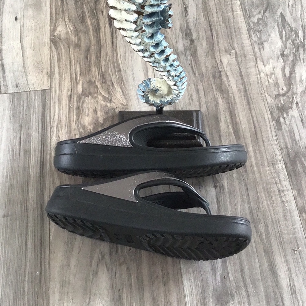 Crocs black and metallic silver flip flops